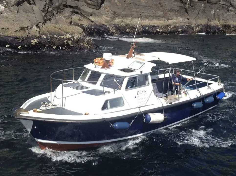 Deva boat anchored off Skellig Michael